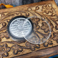 Silver recovery coin with serenity prayer engraving on a wooden box with floral carvings